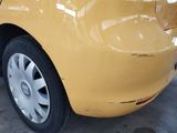 a yellow car that is parked in a garage