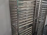 many racks of food that are lined up in a room