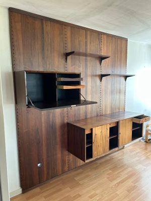 a room with a wooden wall and a tv on the wall