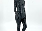 une image représentant une statue de femme debout sur une surface blanche
