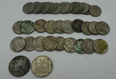 some old coins are sitting on a table with a white background