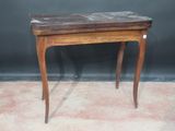 a small wooden table with a marble top on it