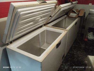 a freezer that is open and sitting in a kitchen