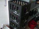 bottles of beer are stacked on top of each other in a room