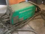 a green machine that is sitting on the floor