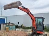 a small excavator that is sitting in the dirt