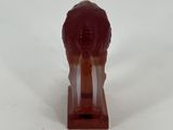 a small figurine of a lion on a wooden stand