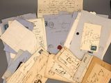 a pile of old letters and envelopes sitting on a table