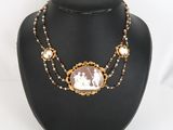 a close up of a necklace on a mannequin with a picture on it