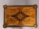 a small wooden box with a decorative design on it