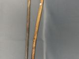 two old walking sticks are on display in a glass case