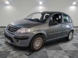 a picture of a small grey car parked in a garage