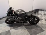 a black motorcycle that is parked on a checkered floor