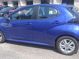 a blue car that is parked in a parking lot