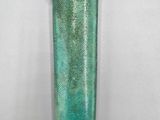 an old green glass lighter with a gold clasp on it