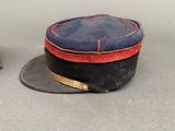 two hats that are sitting next to each other on a table