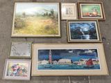 many framed pictures on the floor next to each other