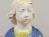 a close up of a statue of a child on a table