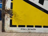 a yellow and black sign on the side of a building