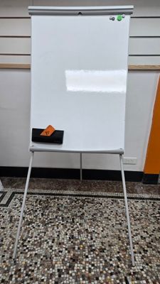 a white board sitting on a stand in a room