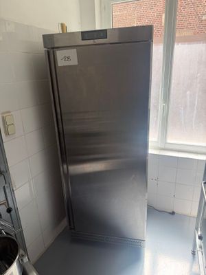 a stainless steel refrigerator in the corner of a kitchen