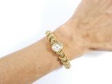 a woman ' s hand that is holding a watch