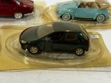 three small toy cars sitting on top of each other
