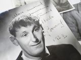 a black and white photo of a man in a tuxedo