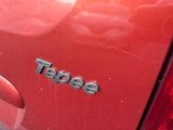 a close up of a red car with a taco logo on it
