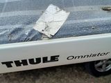 a white truck with a mattress on the back of it