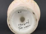 a white vase with writing on it sitting on a table