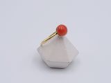 an image of a ring with a red stone on it