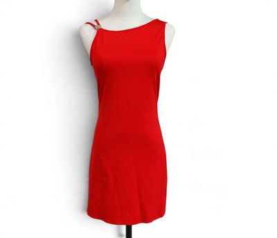 the red dress is on a mannequin stand against a white wall