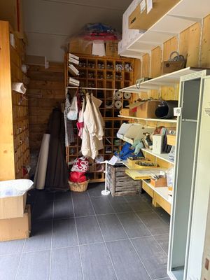 une photo d'une pièce avec un réfrigérateur et des étagères