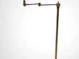 brass floor lamp with a brown shade on a white background