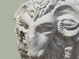 a statue of a ram with a large horn on it ' s head