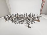 a group of toy soldiers that are standing in front of a white backdrop