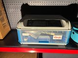 a plastic box with a lid on a shelf in a store