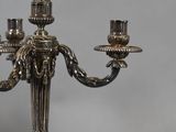 a silver candelab with three candles on it