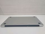 a silver tablet computer sitting on a white surface