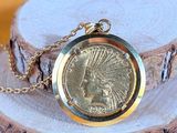 an image of a gold plated necklace with a native indian head on it