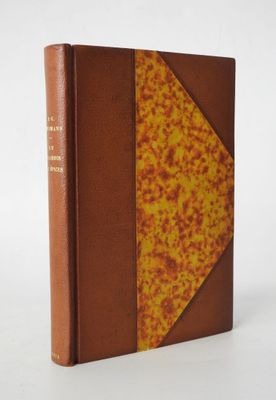 an old book with a brown cover sitting on top of a white table
