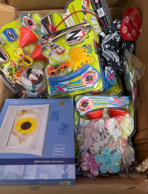 a cardboard box filled with toys and other items