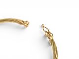 a close up of a gold bracelet on a white background