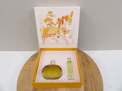 a yellow box with a perfume and a card on it