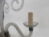 a glass candle holder with a glass candle on it