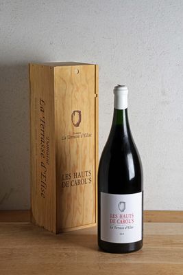 a bottle of wine sitting next to a box on a table