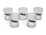 four shot glasses with a ship on them sitting next to each other