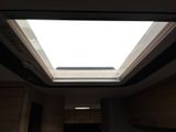 a skylight above a kitchen sink in a small room