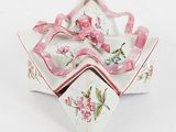 a small white bowl with pink flowers on it